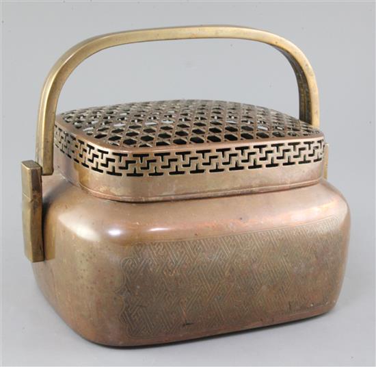 A large Chinese copper alloy hand warmer, 17th / 18th century, width 27cm